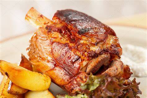 Illustrative photo of pressed roasted potatoes and pork knuckle